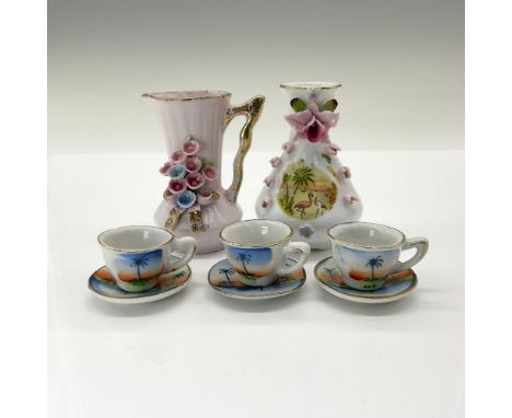 This charming collection features a delightful pink Lefton pitcher adorned with delicate flowers and gold gilded accents, a p