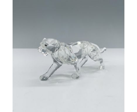 Regal crystal clear faceted figure that depicts a leopard in a walking stance with yellow brown eyes. This figure was part of
