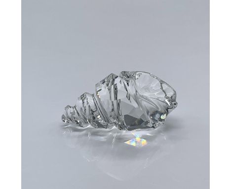 Features a sleek crystal conch shell. This item has its original box measuring 3.25"L x 3.25"W x 2.5"H. Swarovski acid mark. 