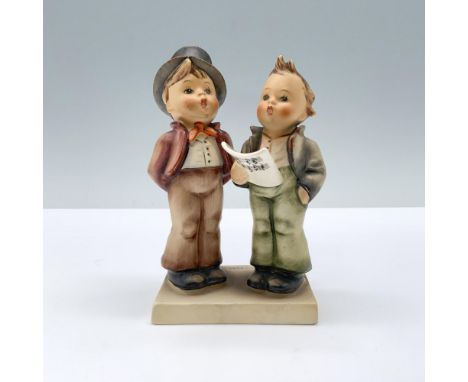 Matte hand painted porcelain figure featuring two kinds singing to a music sheet. M.I. Hummel impressed. Goebel backstamp. Di