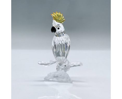This charming bird features a clear crystal facetted body, a black beak and yellow crest. This item has its original box meas