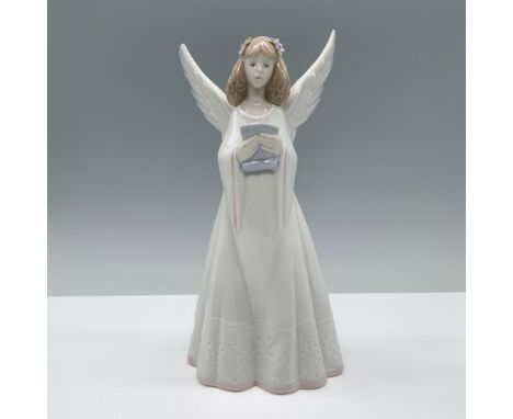 Glossy finish. Figure of an angel holding a music sheet with flowers on her hair. Lladro backstamp. This item has its origina