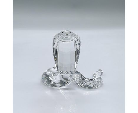 Made of clear facetted crystal with black eyes and a rhodium forked tongue. This item has its original box measuring 5"L x 5"