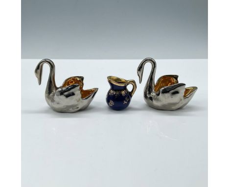 Includes two elegant swan-shaped pieces with a shiny silver exterior and a vibrant gold-tone interior and a cobalt blue pitch