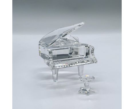 This delightful piano and stool are made from clear crystal. This item has its original box measuring 6"L x 6"W x 4.5"H. Pian