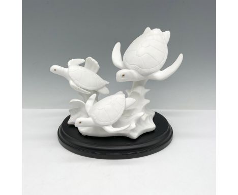 Hand crafted white bisque sculpture of swimming turtles. Lenox backstamp. This item has a wooden base included 6"L x 5.5"W x 