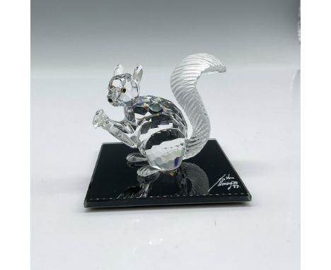 Figure is made from clear crystal with frosted tail and holds a crystal chaton in his paws. Swarovski backstamp. 208433. This