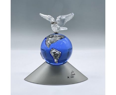 Designed to celebrate the new Millennium. It's comprised of a blue globe over a silver colored base with a clear crystal dove