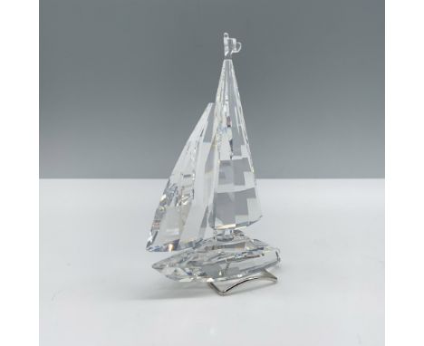 Handsome crystal clear faceted figure that depicts a sailboat with a rhodium metal stand for additional stability. This figur