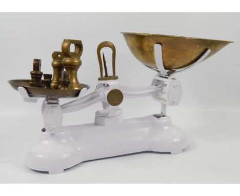 A pair of cast and brass scales, with six weights.