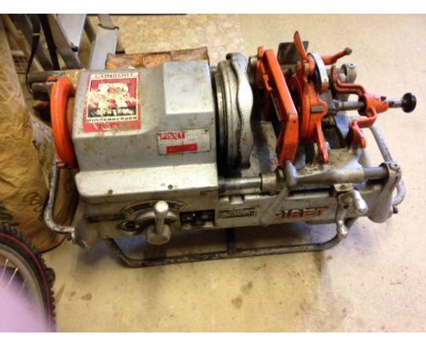 A 3PSG pipe threading machine, elevated upon four legs with a selection of operating tools, 240/110volts. Viewing on site in 