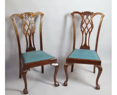 A set of six mahogany dining chairs, in the Chippendale manner with pierced vase splats, drop-in seats and cabriole legs with