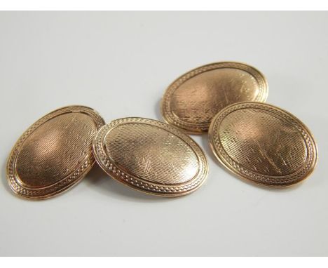 A pair of early 20thC 9ct rose gold cufflinks, with engine turned decoration, 4.8g.