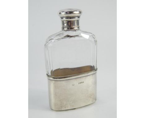 A Victorian cut glass and silver mounted spirit flask, with slice cut decoration to the shoulders of the glass flask, the det