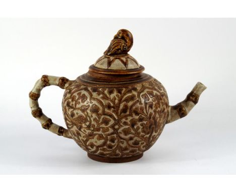 An Chinese stoneware teapot, with bird and foliage decoration in brown on a grey crackle glazed ground, and with a bird knob 