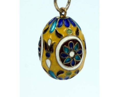 A Russian champleve egg, with yellow turquoise dark blue white purple and olive enamel decoration with mark RA 84 mark, and T