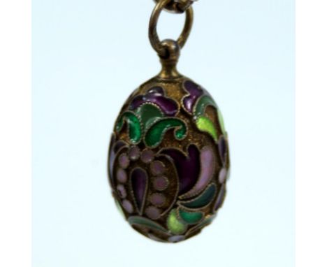 A Russian champleve egg, with olive white plum dark red dark green enamel decoration with mark AG 84 mark, and Tbilisi/Tifili