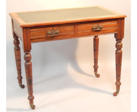 A Victorian walnut writing table, the rectangular top with a green leatherette insert above two frieze drawers on turned tape