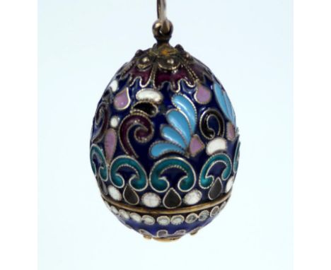 A Russian champleve egg, in dark blue enamel with light blue white turquoise black and purple floriate decoration with mark A