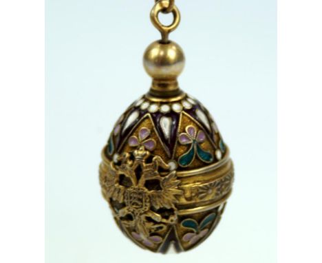 A Russian champleve scent holder, with chain, in gilt and enamel decoration bearing double headed eagle crest, having AM make