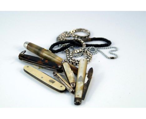 A pair of knives, and a cheroot holder, casings including bone, abalone, tortoiseshell, etc, (6).