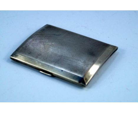 A George V silver cigarette case, of slightly curved form with engine turned decoration, Birmingham 1924, 2oz.