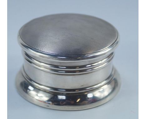 A George V silver circular powder box, with hinged lid incorporating interior mirror, with engine turned decoration, Birmingh