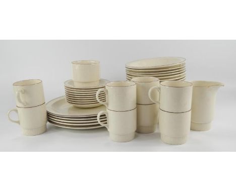 A Poole Pottery part dinner and tea service, in biscuit colour, comprising dinner plates, side plates, bowls, saucers, cups, 