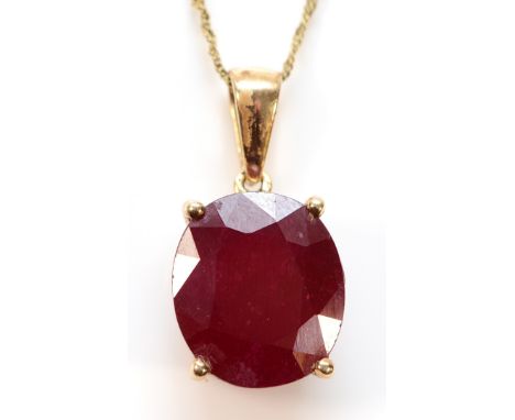 A 9ct gold oval cut ruby pendant on a chain, 14mm x 12mm ruby, 6g