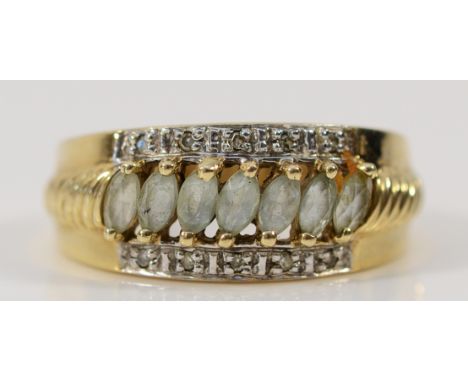 A 9ct gold aquamarine and diamond three row dress ring, with patterned shoulders, M, 3g