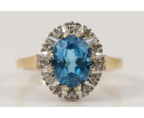 A 9ct gold blue topaz and diamond cluster ring, London 1987, 9mm x 6mm topaz, L, 3.3g