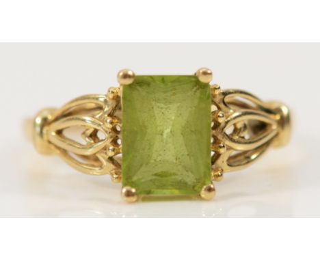 A 9ct gold peridot dress ring with patterned shoulders, 8mm x 6mm peridot, L, 1.9g