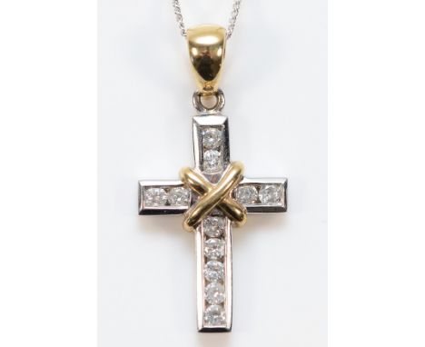 A 9ct white and yellow gold brilliant cut diamond cross pendant on a chain, 18mm, 2.8g