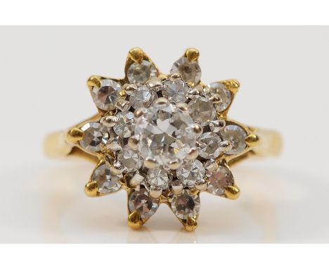 An 18ct gold central diamond outer white gemstone cluster ring, old cut brilliant diamond approx 0.25ct, estimated P1, HI, I,