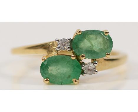 a 9ct gold emerald and diamond cross over ring, N 1/2, 2.3g