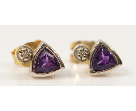 A pair of 9ct white gold diamond and amethyst earrings with scroll backs, 1.1g