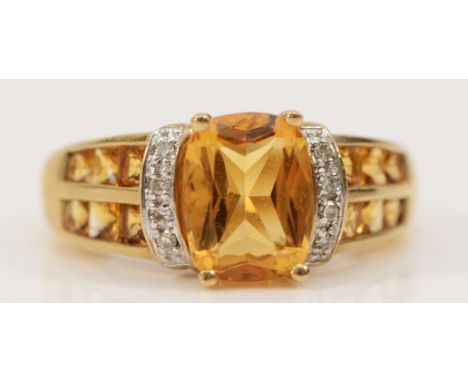 A 9ct gold citrine and diamond dress ring, 9mm x 7mm central citrine, J 1/2, 3.5g
