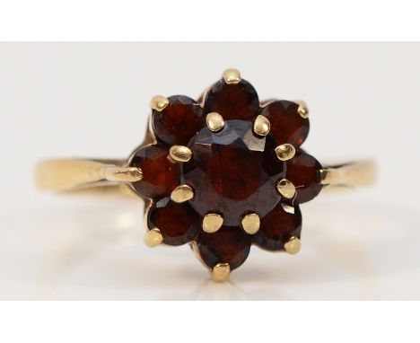 A 9ct gold garnet floral cluster ring, Birmingham 1967, M 1/2, 2.7g