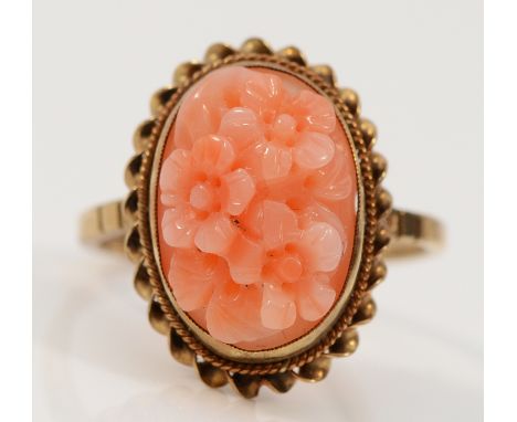 A 9ct gold carved coral floral dress ring, Birmingham 1986, M, 2.8g
