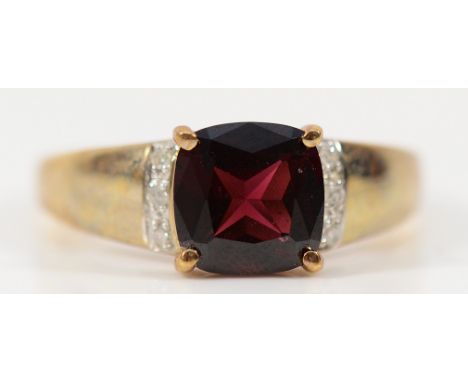 A 9ct gold garnet dress ring with diamond set shoulders, Q, 3.1g