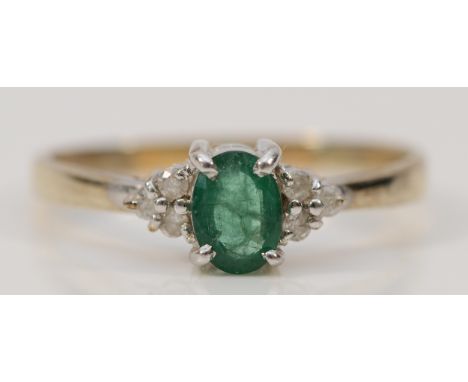 A 9ct gold emerald solitaire ring with diamond set shoulders, X, 2.8g