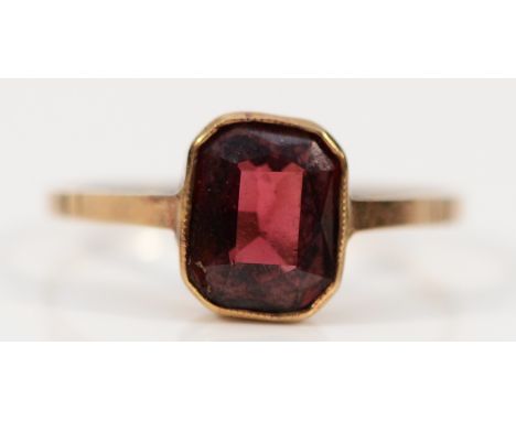 A 9ct gold garnet dress ring, 7mm x 6mm garnet, chip to one corner, M 1/2, 1.3g