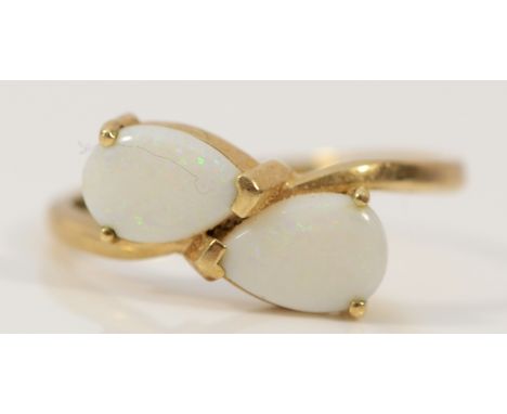 A 9ct gold opal two stone cross over ring, S, 2.6g