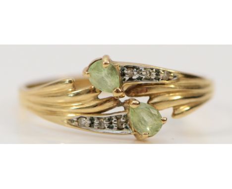 A 9ct gold green gemstone and diamond cross over ring, T, 1.9g