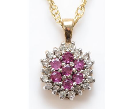 A 9ct gold ruby and diamond cluster pendant on a chain, 2.8g