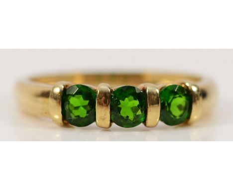 A 9ct gold green gemstone three stone ring, N, 1.8g