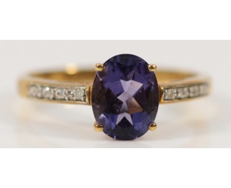 A 9ct gold amethyst solitaire ring with diamond set shoulders, 9mm x 6mm amethyst, Q, 2.1g