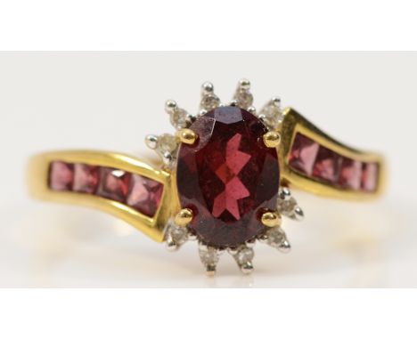 A 9ct gold garnet and diamond dress ring with garnet set shoulders, R, 2.9g