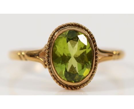 A 9ct gold peridot dress ring, 9mm x 6mm peridot, O, 1.8g