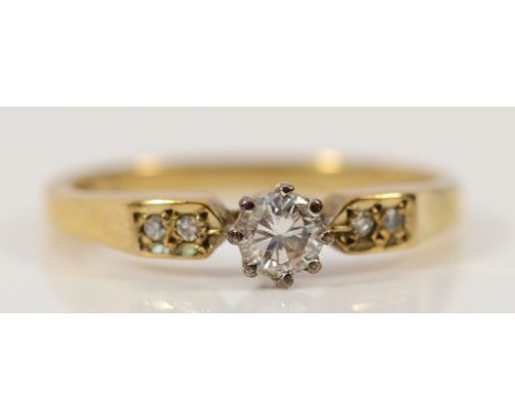 A 9ct gold brilliant cut diamond solitaire ring with diamond set shoulders, Birmingham 1988, approx 0.15ct, N 1/2, 2.4g